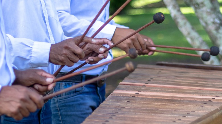 People playing a marimba