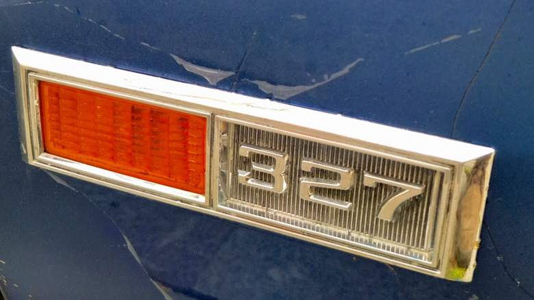 Close-up of the Chevrolet 327 logo on a blue car