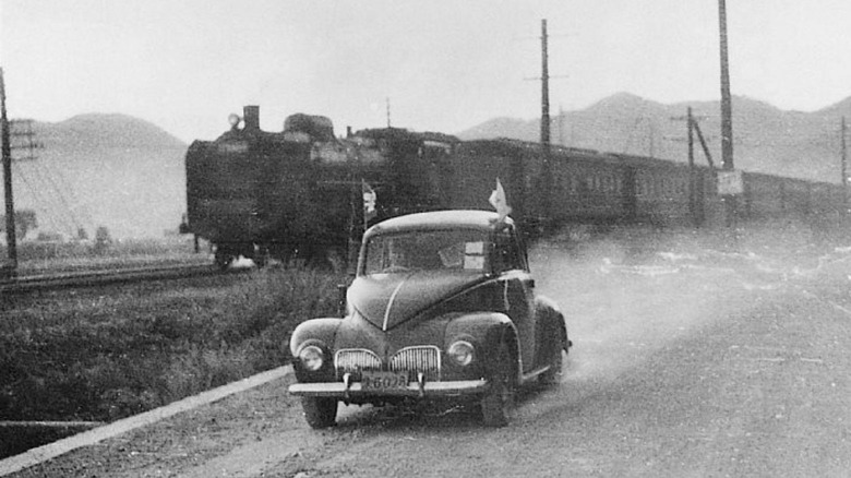Model SA car racing against a train