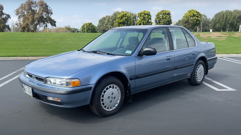 Front 3/4 view of the blue 1990 Honda Accord LX with over one million miles in a parking lot