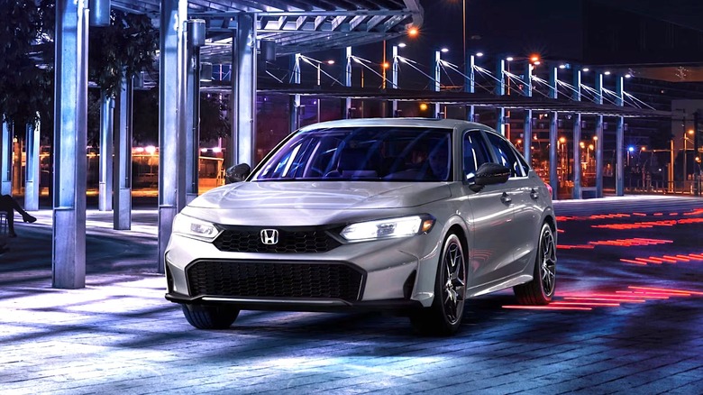 2026 Honda Civic driving through a lighted parking lot