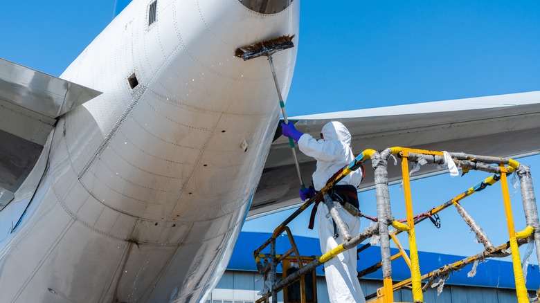 Man washing airplane