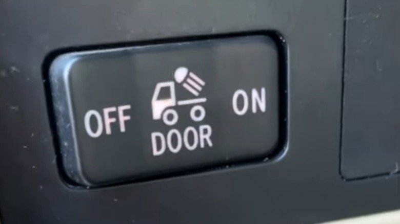 The rear lights button on a pickup truck dashboard.