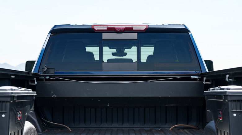 The back lights of a black pickup truck.