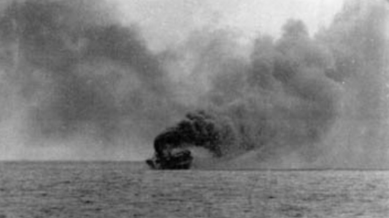 The HMS Glorious emits plumes of smoke as it sinks to the bottom of the Arctic Ocean.