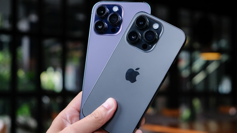 hand holding two iphones