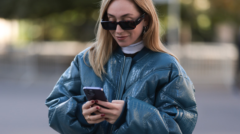 woman using purple iphone