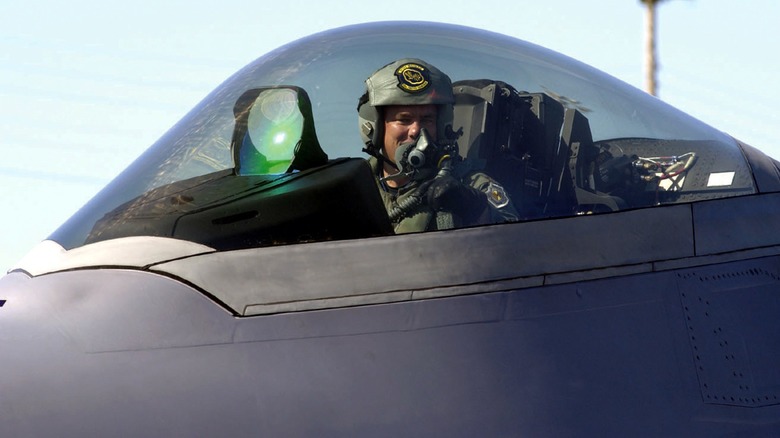 A pilot inside the cockpit of an F-22 Raptor