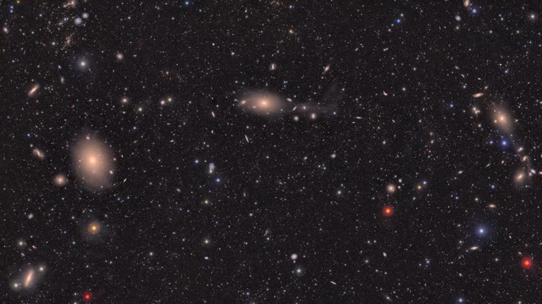 A shot of the cosmos taken by the LSST Camera at the Vera C. Rubin Observatory. It's a large, very starry night sky with many multicoloured astronomical objects.