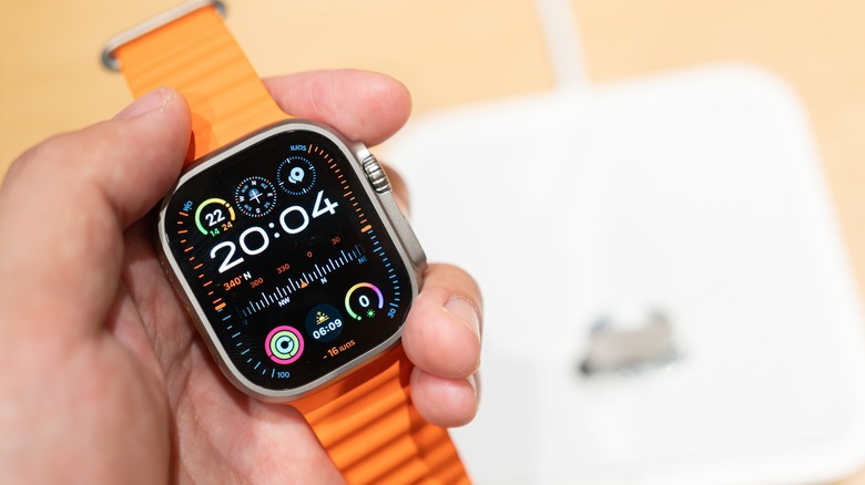 Hand holding Apple Watch Ultra 2