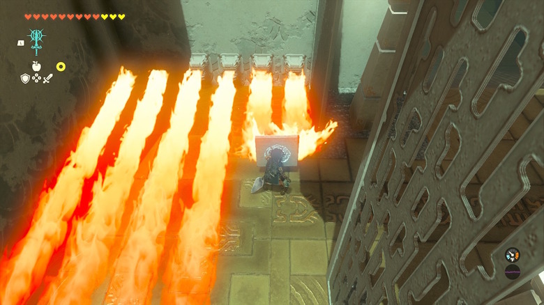 Link blocking spouts of fire with a large stone board attached to his shield