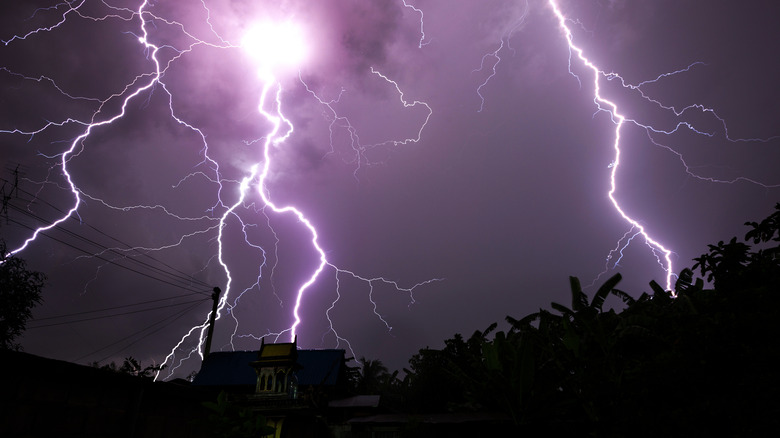 Terrifying lightning strikes on top of a house