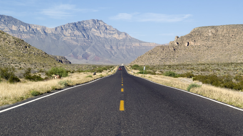 Two lane road leading to mountains