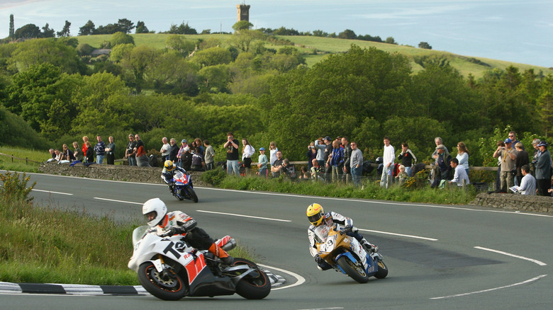 Motorcycle riders negotiating right-hand corner on Isle of Man TT Mountain Course
