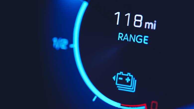 Close-up of an electric vehicle display showing 118 miles of driving range