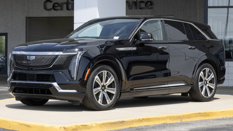 A black Cadillac Escalade IQ displayed outside a dealership
