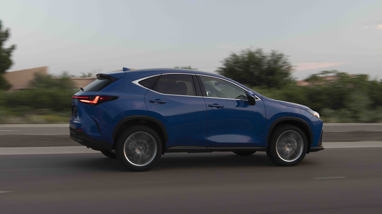 Blue Lexus NX Hybrid on road the road, side view