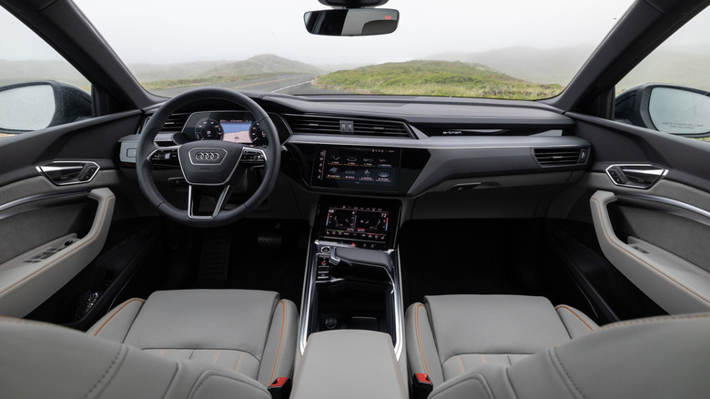 Audi Q8 E-Tron interior as viewed from back seat in country setting