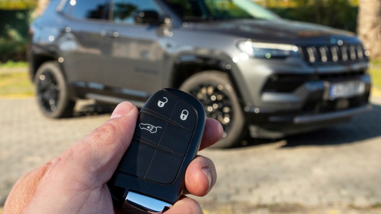 A person holding car key in focus