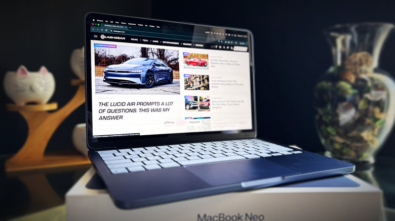 A MacBook Neo sitting on top of its product box