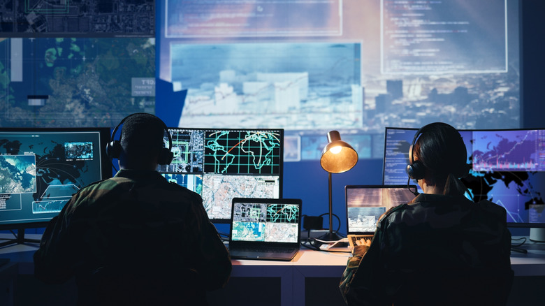 Military control room, computer screen and team with surveillance, headset and tech communication