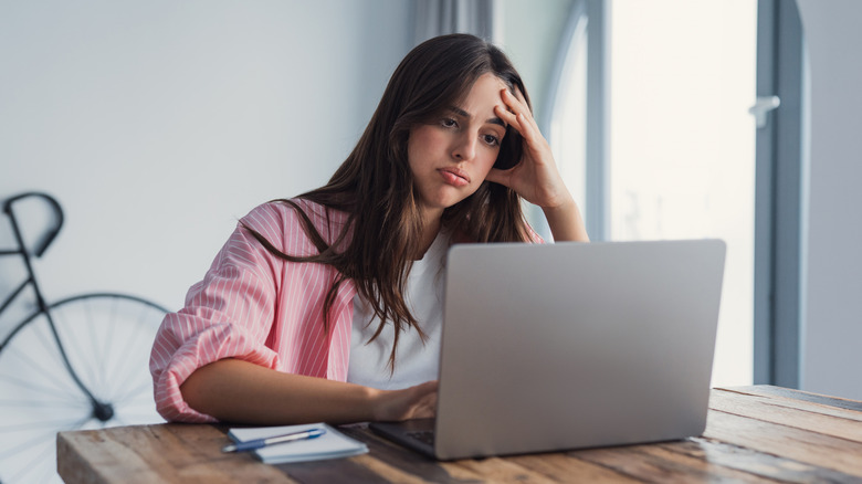 Frustrated woman using a laptop