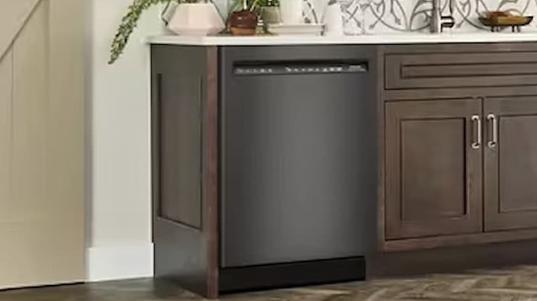 A KitchenAid black stainless steel dishwasher is in a kitchen.