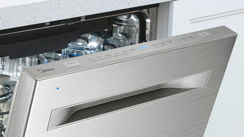An open Midea Stainless Steel dishwasher with a visible control panel.