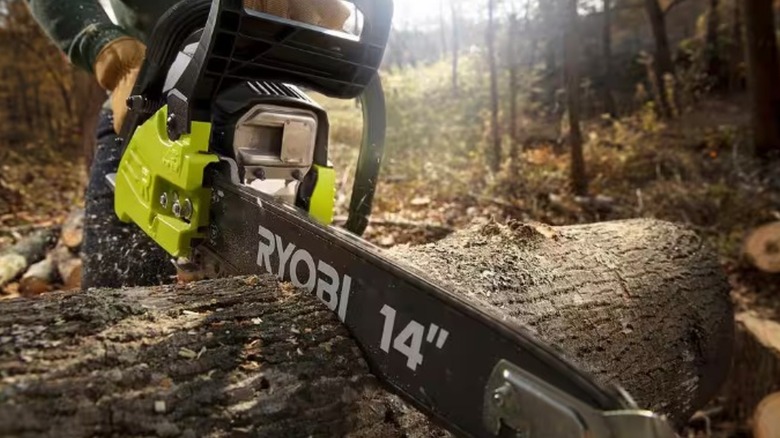 Ryobi gas chainsaw cutting through a log