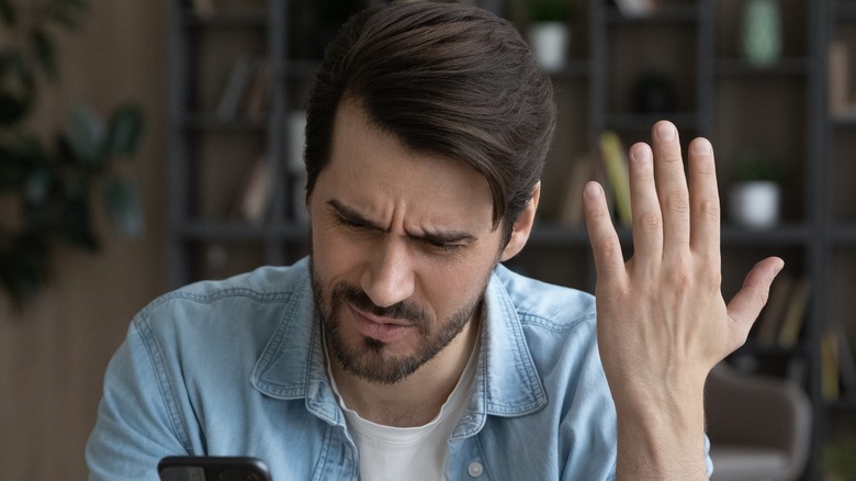 Frustrated person with phone