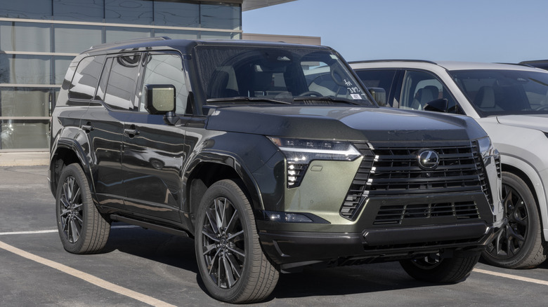 A black 2025 Lexus GX 550 in a parking lot.