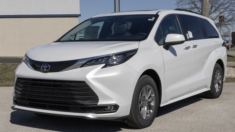 A white Toyota Sienna, parked.