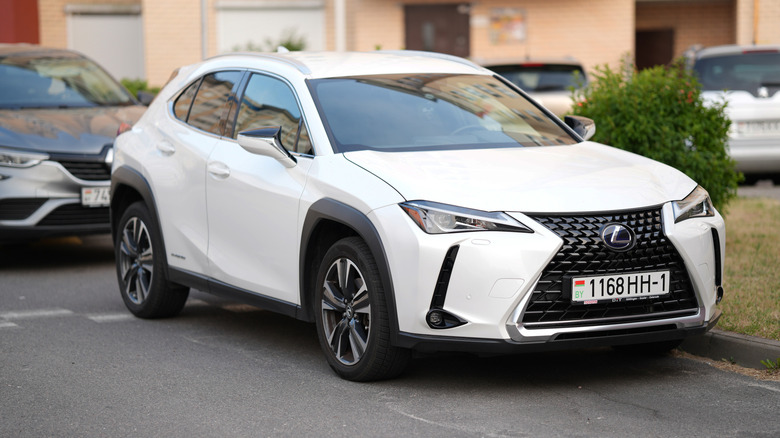A white Lexus UX parked in a residential area.