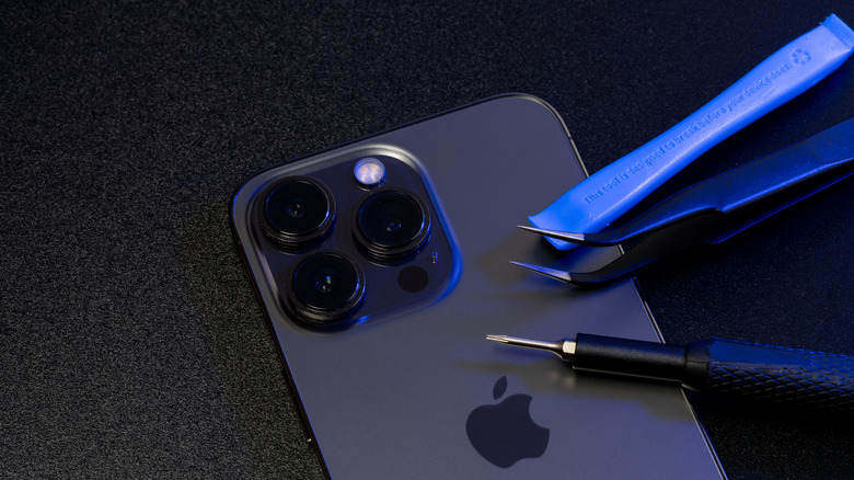 repair tools on top of a Pro iPhone model