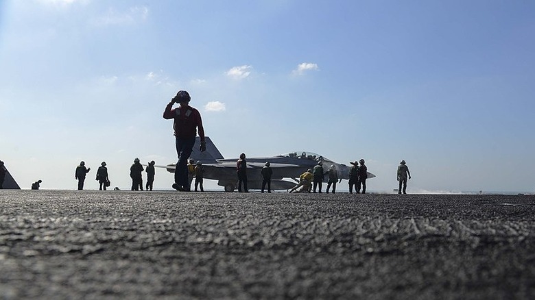 Sailors prepare an F/A-18F Super Hornet aboard the USS Harry S. Truman