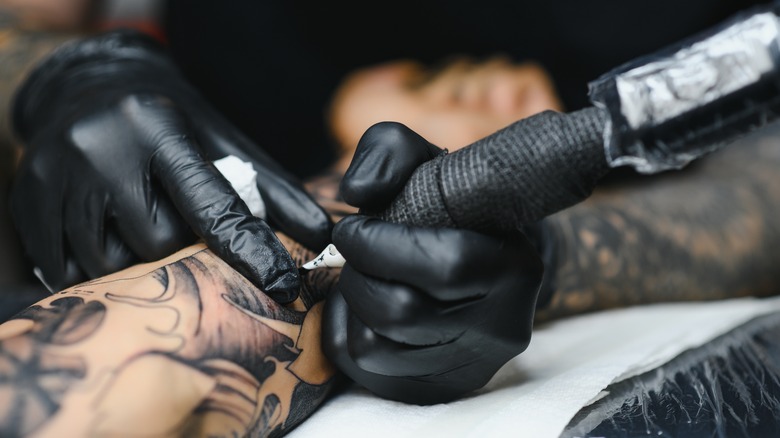 Tattoo artist working