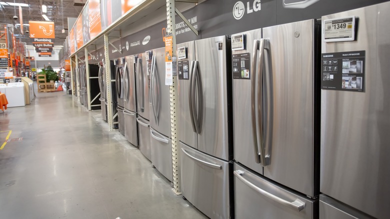 row of refrigerators in a Home Depot
