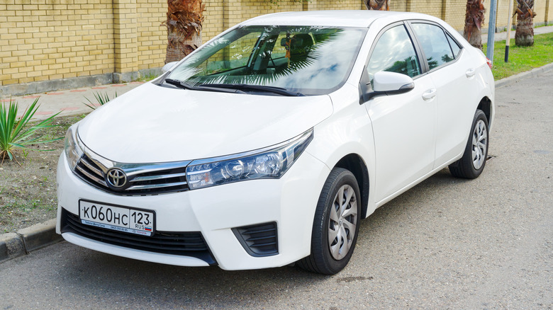A white Toyota Corolla parked