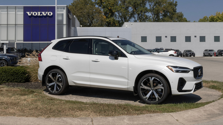 White Volvo XC60 parked outside a Volvo dealership