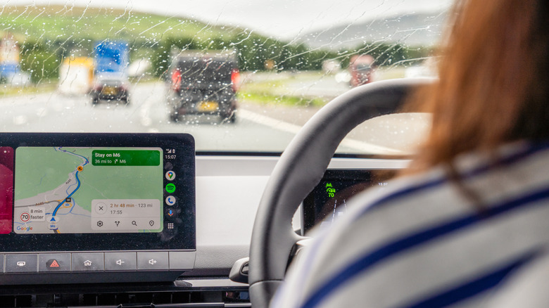 A driver in the rain navigates with Google Maps