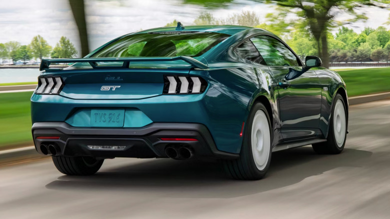 back of Ford Mustang GT driving down scenic road