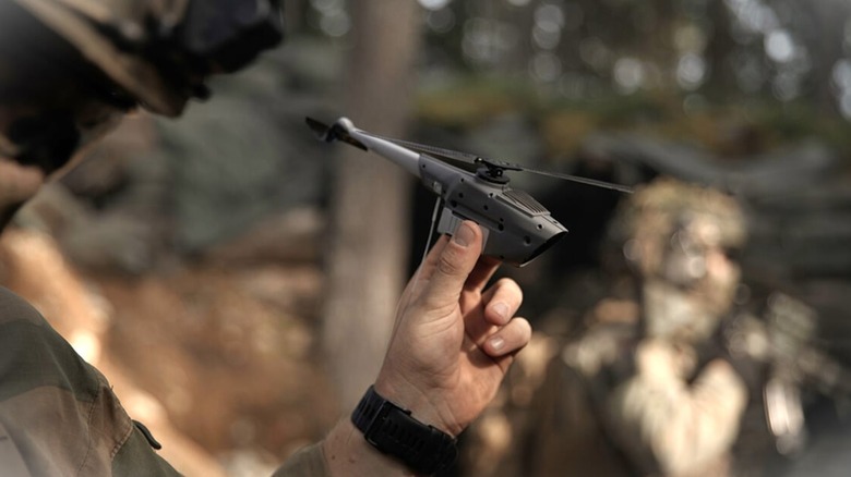 A Teledyne FLIR Black Hornet Nano held by a soldier