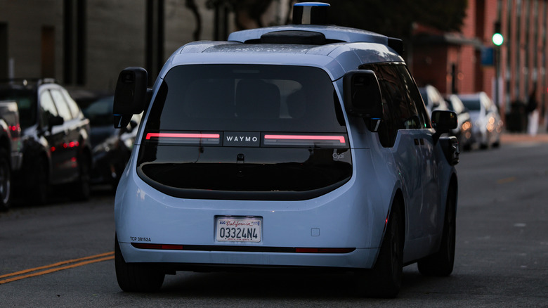 The back of a Waymo self-driving car on the street.