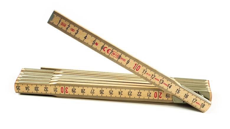 A wooden folding rule against a white backgroud