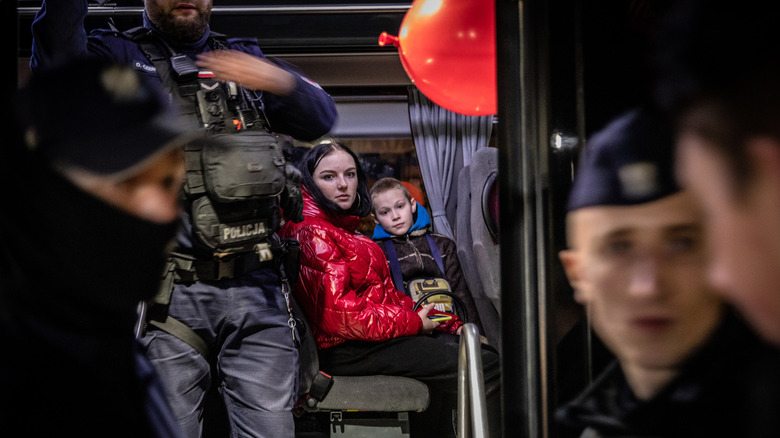 Ukrainian refugees with police