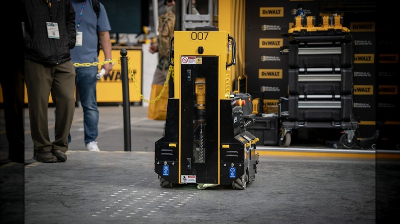 DeWalt's DALE robot drilling holes in concrete at a trade show.