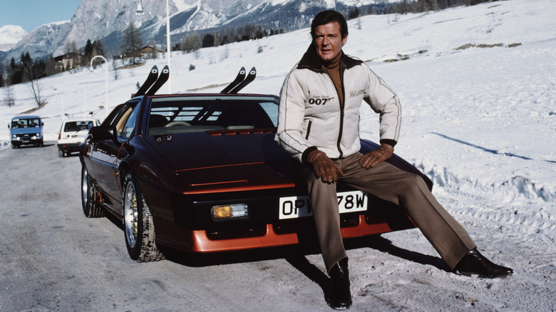English actor Roger Moore poses as 007, with a Lotus Esprit Turbo, on the set of the James Bond film 'For Your Eyes Only', February 1981.