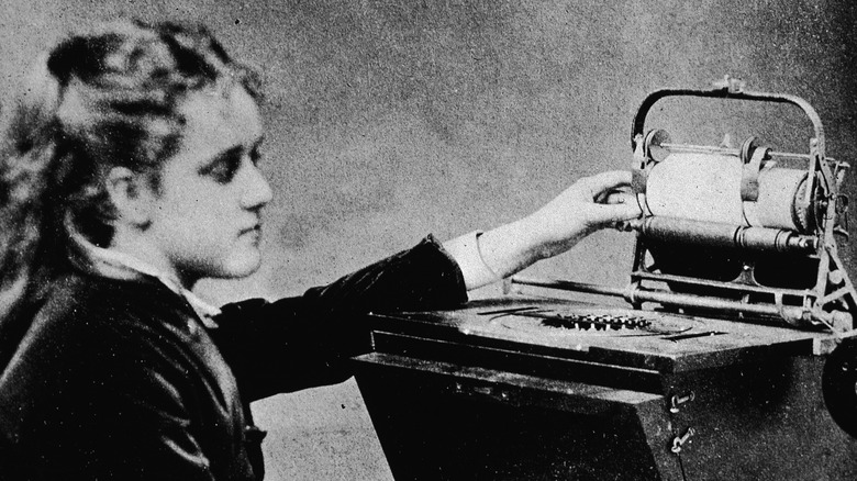 woman operating an ancient typewriter