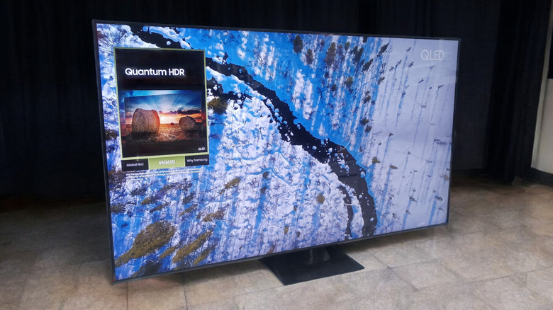 A QLED Quantum HDR smart TV positioned on the floor