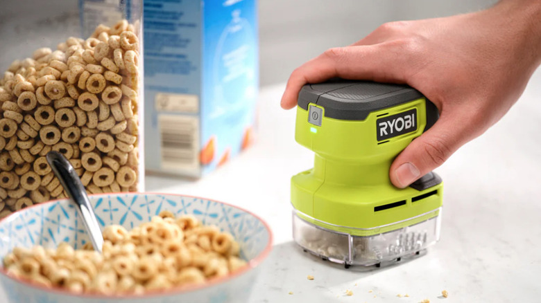 Ryobi USB Lithium Desktop Vacuum cleaning up cereal